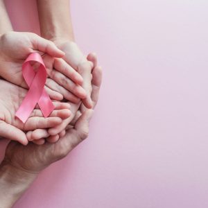 hands holding pink ribbons, Breast cancer awareness and October Pink day